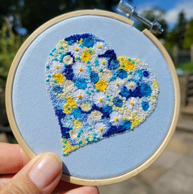 Blue flower filled heart hand embroidered 4 inch hoop wall hanging
