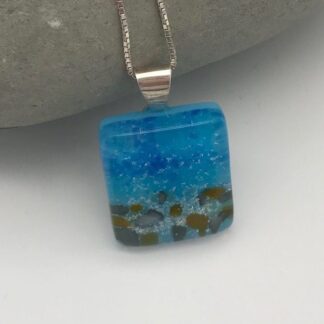 Handmade fused glass seascape pendant with sand from Australia