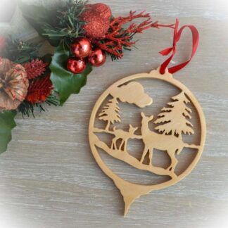 Round wooden Christmas decoration with woodland deer scene and red ribbon