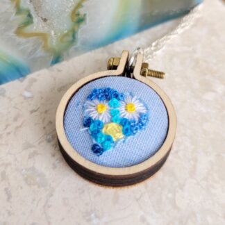 Blue heart filled with hand embroidered flowers 2.5cm embroidery hoop framed pendant.