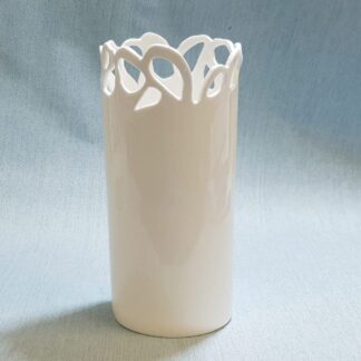 Tall white ceramic vase with hand cut decoration