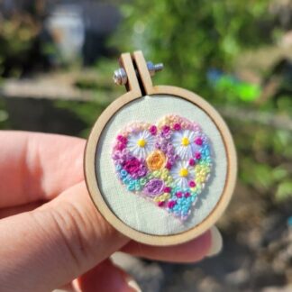 Hand embroidered heart filled with flowers 4 cm hoop brooch.