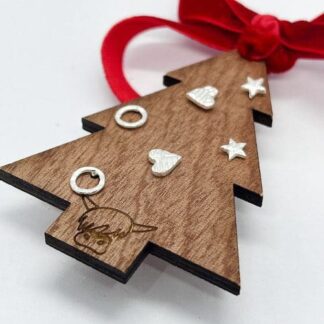 Three Pairs of Dainty Silver Earrings Presented On Christmas Tree Decoration