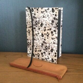 Handmade notebooks covered in an abstract fabric