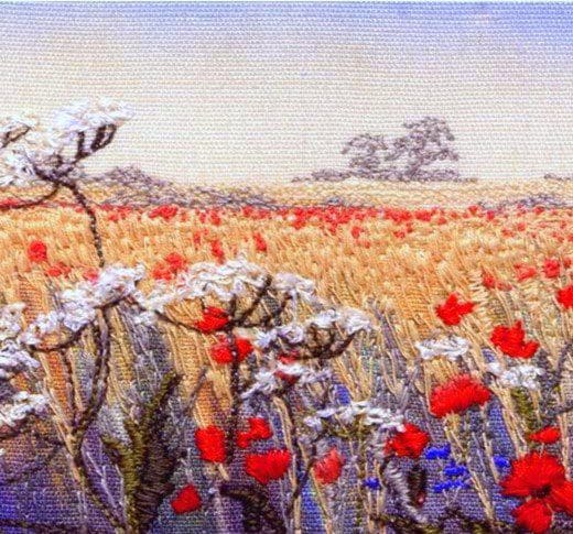 Embroidered picture of a cornfield and poppies