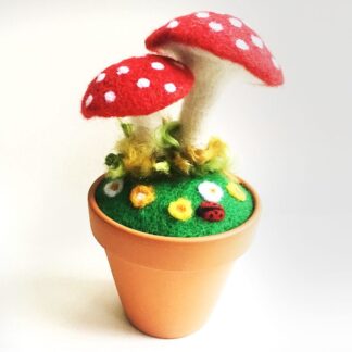 Needle felted toadstools in a flower pot