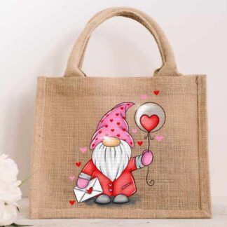 Small natural jute bag featuring a colorful illustration of a Valentine's gnome wearing a heart-patterned hat and holding a heart balloon and envelope.