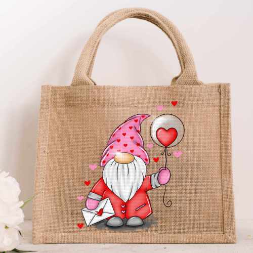 Small natural jute bag featuring a colorful illustration of a Valentine's gnome wearing a heart-patterned hat and holding a heart balloon and envelope.