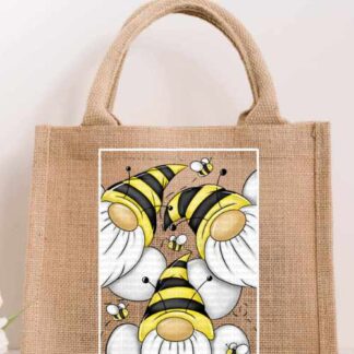 Small natural jute tote bag featuring a bright illustration of three gnomes in yellow and black striped bumblebee hats with small bees flying around them.