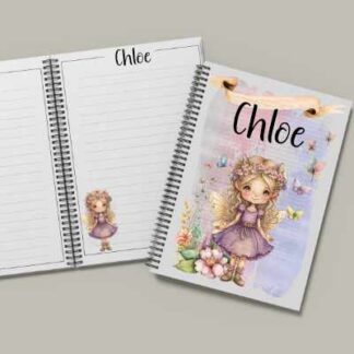A spiral-bound A5 notebook featuring a full-bleed illustration of fairies, flowers, and butterflies on a white background. The name "Mya" is printed in the center in a simple black font.
