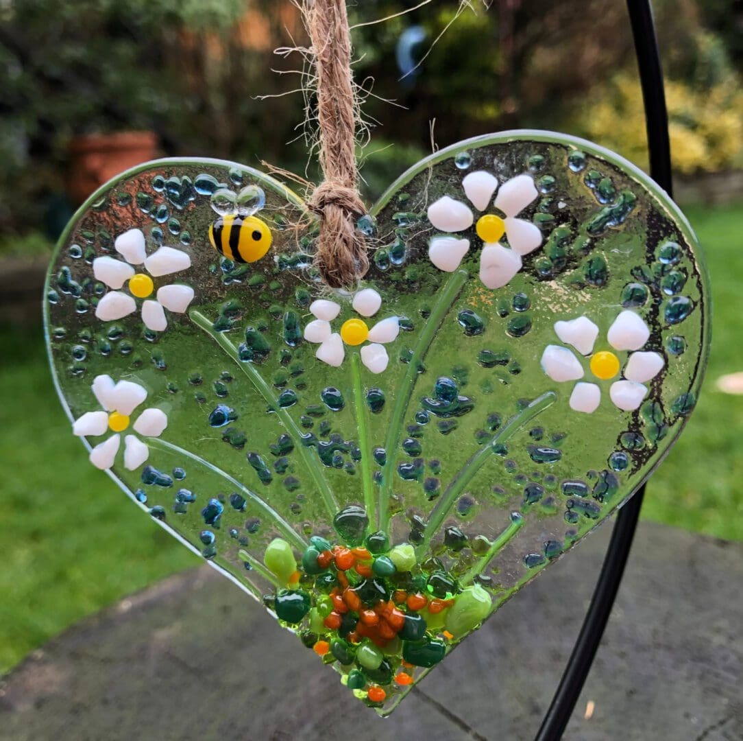 Fused Glass Heart Hanger with little daisy flowers and small bee. Handmade approx 9cm. Other designs are also avliable on this heart.