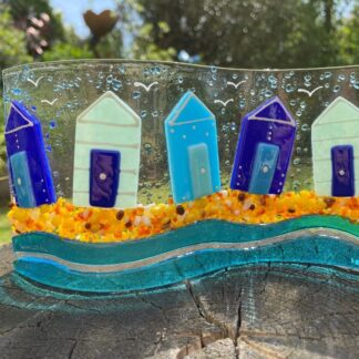 Handmade fused glass beach hut wave, beautiful blue beach huts sitting on the beach with seagulls in the air.