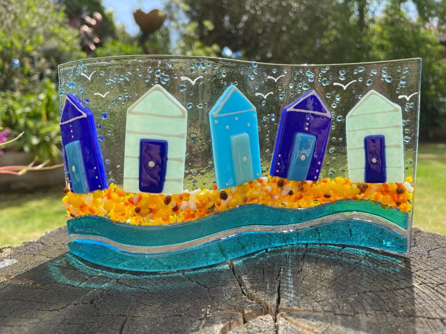 Handmade fused glass beach hut wave, beautiful blue beach huts sitting on the beach with seagulls in the air.