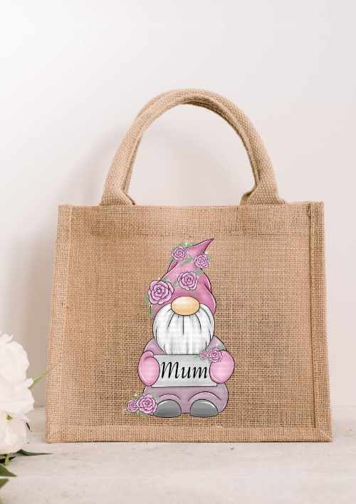 Small natural jute tote bag featuring a pink floral gnome holding a white sign that says Mum in elegant black script.