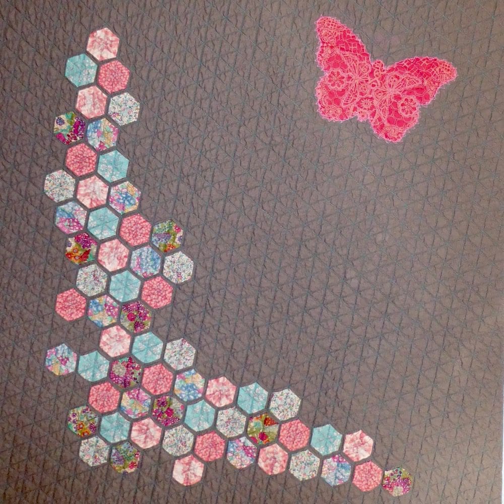 Modern baby quilt with hexagons and butterfly