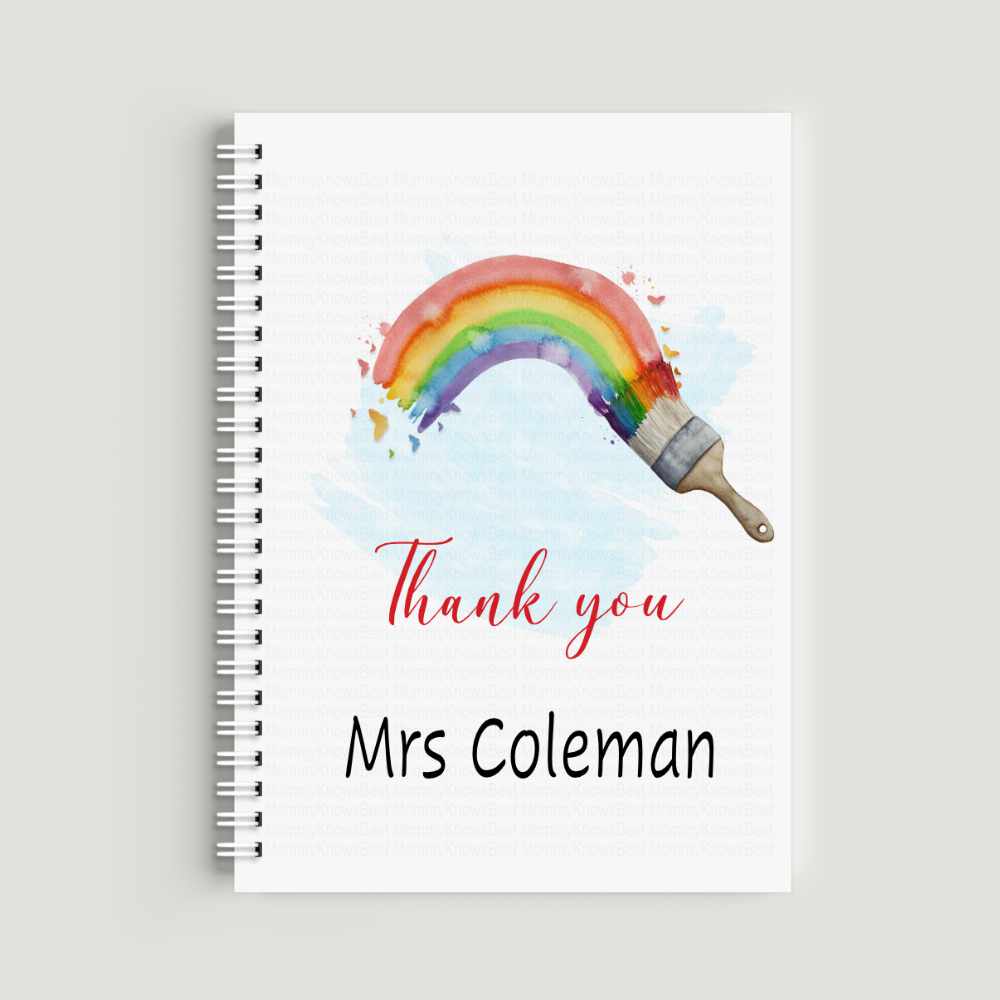 A spiral-bound A5 notebook with a watercolor illustration of a paintbrush creating a bright rainbow arc. The text "Thank you Mrs Coleman" is printed on the front in red and black lettering.
