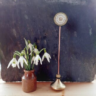 Flower style sculpture made from recycled metal with watch and clock parts