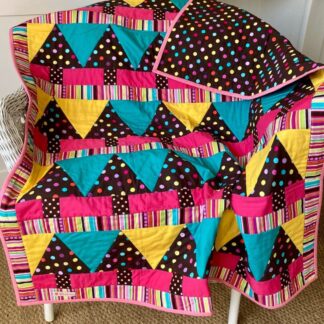 Bright child's quilt with spotty trees