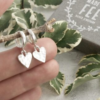 Sterling silver 9mm wide hammered hearts suspended from 12mm huggie leverback hoop earrings