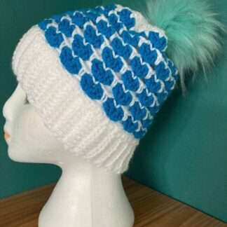 A Crochet Blue and White Beanie Hat with detachable Faux Pom Pom
