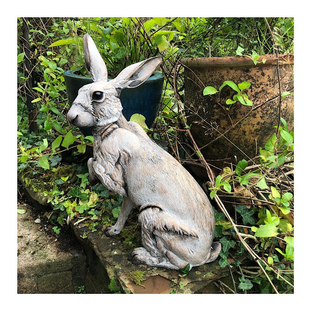 Large sitting Hare sculpture in a garden setting