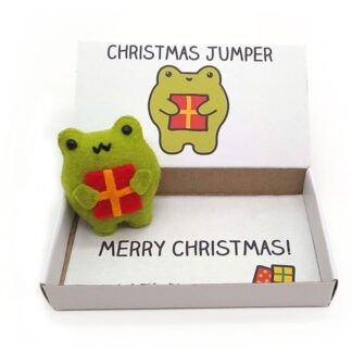 Cute handmade frog Christmas gift. A happy felt frog holding a Christmas presentin an illustrated matchbox that reads Christmas Jumper on the outside and Merry Christmas on the inside.