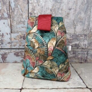 A velvet door stop in a green contemporary print.