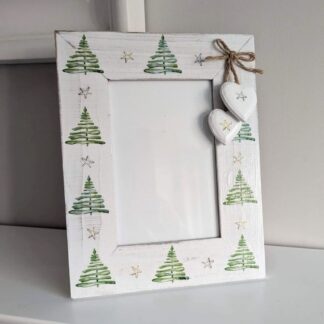 6 x 4 whitewashed frame decoupaged with a repeating Christmas tree and stars design and finished with two hearts hanging from a twine bow