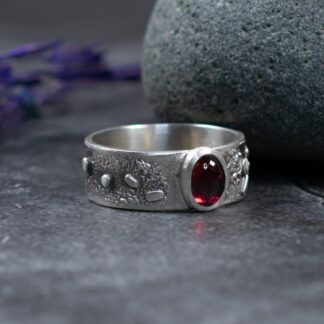 Sterling Silver Textured Garnet Ring. Matt Silver finish with a beautiful deep red natural oval Rhodolite Garnet Gemstone.