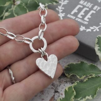 17cm wide chunky solid silver hammered heart pendant necklace suspended by a double jump ring bail from a 12mm diameter hammered silver circle on a large silver oval belcher chain.