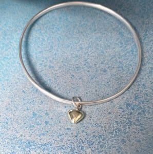 silver bangle with gold heart