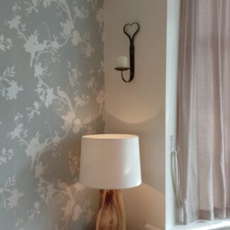 Hand forged wall candle holder with a heart shaped top.
