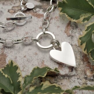 Chunky 1.7mm wide smooth solid silver heart suspended from a 15mm silver circle by a double jump ring on a large loose linked belcher chain necklace