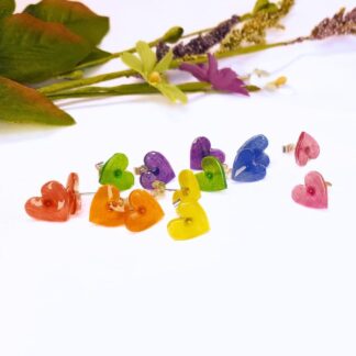 Little heart shaped earrings in a range of colours with a sterling silver stud fitting.
