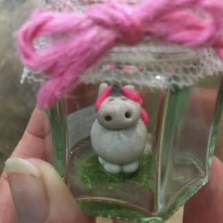unicorn miniature clay figure in a jar
