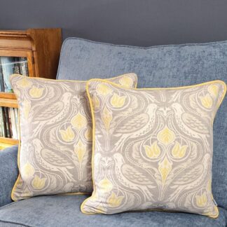 Two Dawn Chorus Cushions on a blue soft