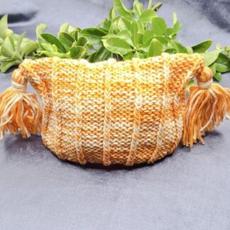 An orange beanie for a 2 or 3 year old toddler child.