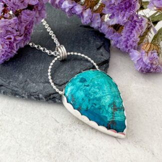 Turquoise green shattuckite gemstone set in a handmade silver necklace