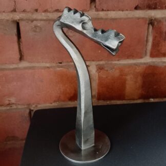 Dragon's head sculpure hand forged by a blacksmith.