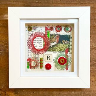 Collage picture made of vintage finds featuring a robin and embroidery