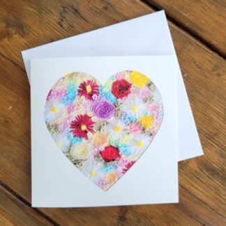 Printed greetings card from original embroidered artwork of a heart filled with embroidered flowers.