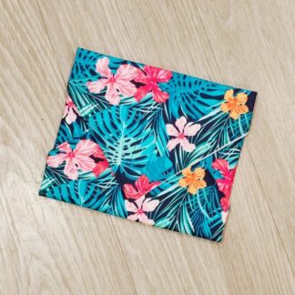 Reusable sandwich wrap with tropical flowers and leaves on a navy blue cotton outer fabric and food-safe PUL lining.