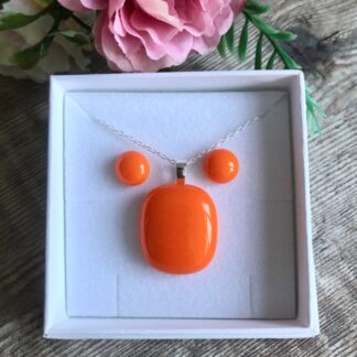 Bright orange pendant and matching stud earrings handmade with fused glass