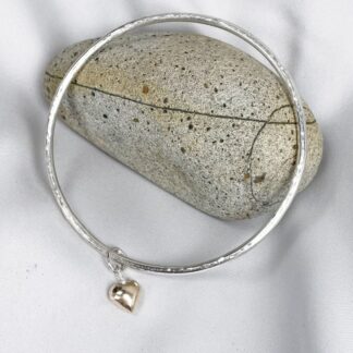 gold heart and silver bangle