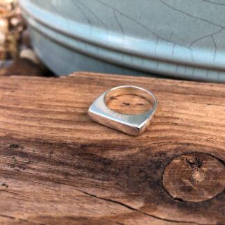 A chunky sterling silver signet ring carved from wax
