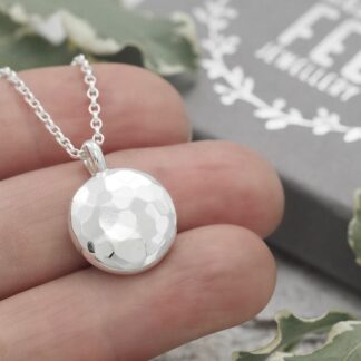 Handmade round domed hammered argentium sterling silver pebble pendant measuring 15.5mm in diameter.