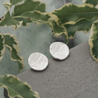 Handmade 11mm diameter roundish slightly concave slate-like textured stepping stone disc stud earrings. Molten organic