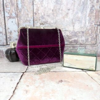 An elegant evening bag in a quilted purple velvet, and with a removable chain handle.