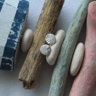 Recycled round silver stud earrings featuring a cuttlefish texture