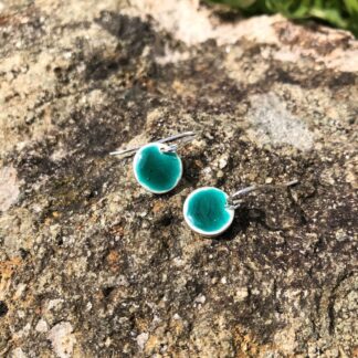Round silver and green turquoise enamel drop earrings.